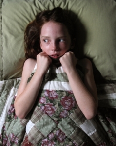 Frightened child in bed